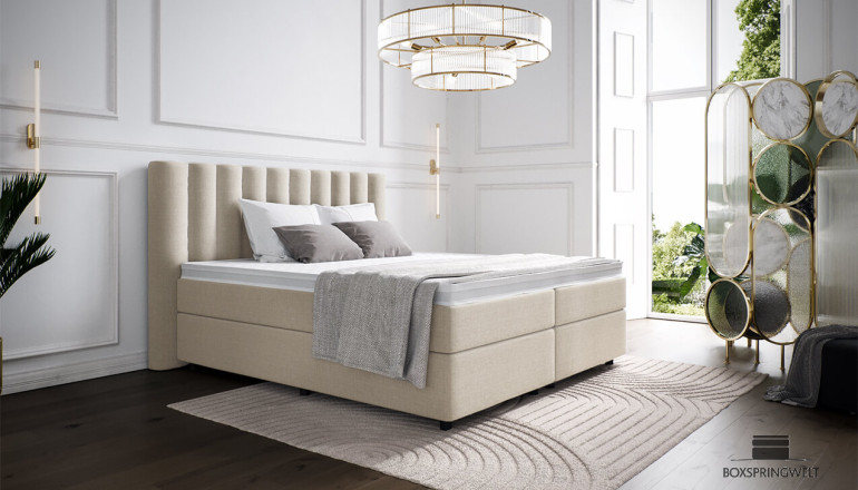 Lit Boxspring Diana 200 x 210 cm en housse Mine Beige. Tête de lit avec saillie latérale. Pieds ronds en noir