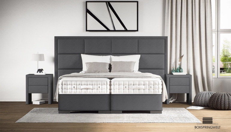 Lit Boxspring de luxe Maximo en gris Mine avec tête de lit dépassant de 10 cm de chaque côté